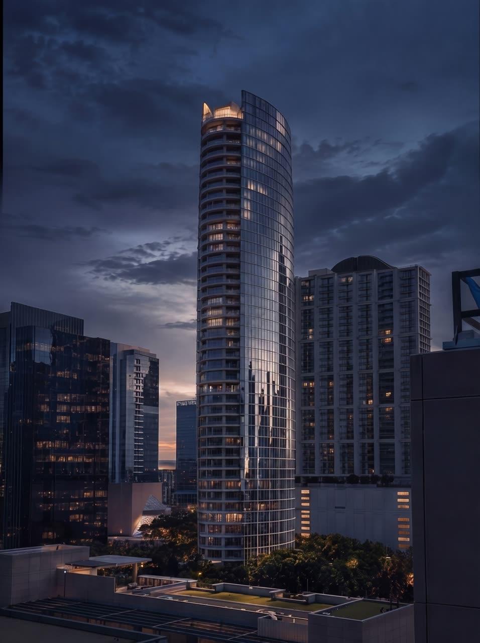Luxury curved-glass residential tower in Dallas at dusk where the interior project was completed.